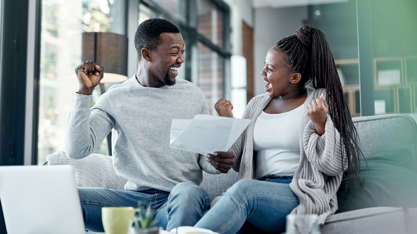 Couple celebrating debt relief success