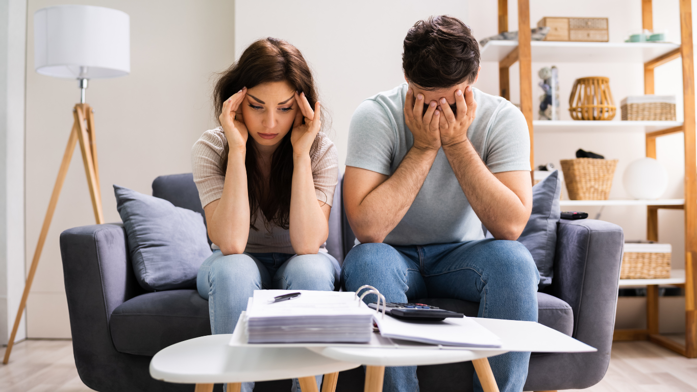 Couple feeling overwhelmed by debt
